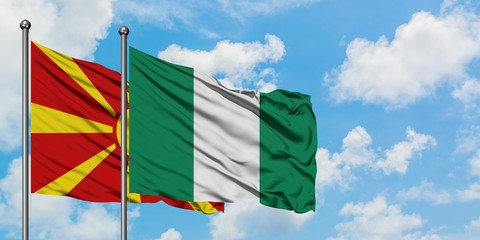 Macedonia and Nigeria flag waving in the wind against white cloudy blue sky together. Diplomacy concept, international relations.