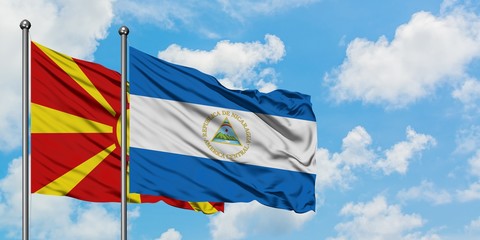 Macedonia and Nicaragua flag waving in the wind against white cloudy blue sky together. Diplomacy concept, international relations.