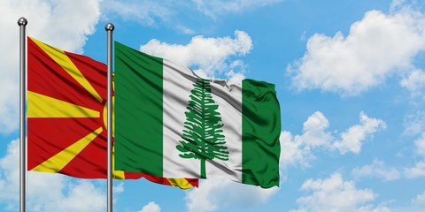 Macedonia and Norfolk Island flag waving in the wind against white cloudy blue sky together. Diplomacy concept, international relations.
