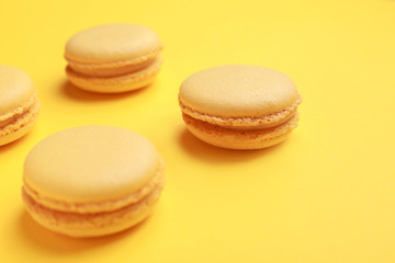 Tasty macarons on color background