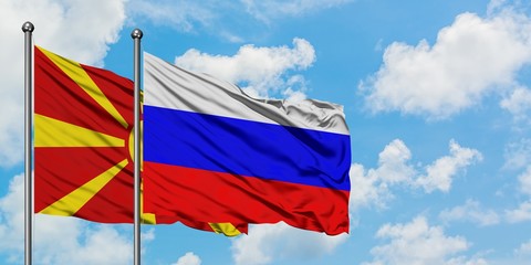 Macedonia and Russia flag waving in the wind against white cloudy blue sky together. Diplomacy...