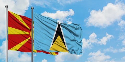 Macedonia and Saint Lucia flag waving in the wind against white cloudy blue sky together. Diplomacy concept, international relations.