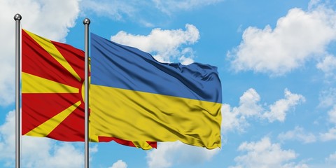 Macedonia and Ukraine flag waving in the wind against white cloudy blue sky together. Diplomacy concept, international relations.