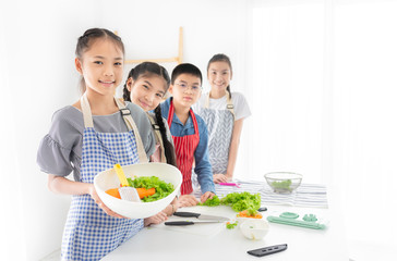 asian children group cooking organic vegetables salad, they holding vegetables with hand, child...