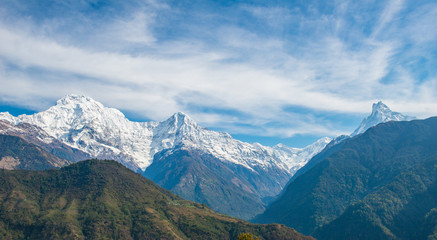 Obraz na płótnie Canvas View of Annapurna range includes Annapurna South (left) - Himchuli (centre) and Machapuchare (far right) view from Ghandruk village in northern-central of Nepal.
