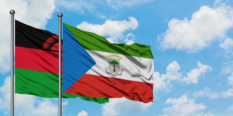 Malawi and Equatorial Guinea flag waving in the wind against white cloudy blue sky together. Diplomacy concept, international relations.