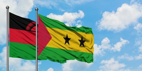 Malawi and Sao Tome And Principe flag waving in the wind against white cloudy blue sky together. Diplomacy concept, international relations.