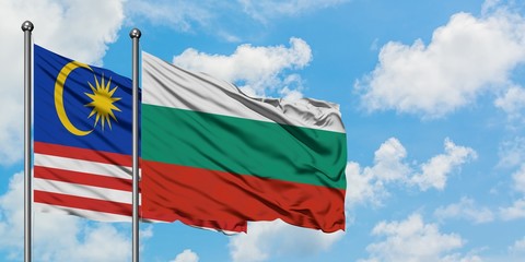 Malaysia and Bulgaria flag waving in the wind against white cloudy blue sky together. Diplomacy concept, international relations.