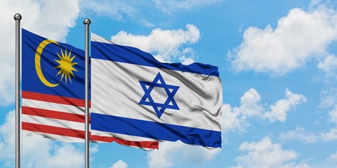 Malaysia and Israel flag waving in the wind against white cloudy blue sky together. Diplomacy concept, international relations.