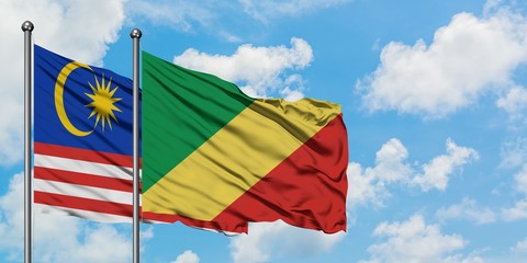 Malaysia and Republic Of The Congo flag waving in the wind against white cloudy blue sky together. Diplomacy concept, international relations.
