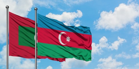Maldives and Azerbaijan flag waving in the wind against white cloudy blue sky together. Diplomacy...