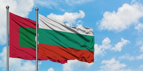 Maldives and Bulgaria flag waving in the wind against white cloudy blue sky together. Diplomacy concept, international relations.