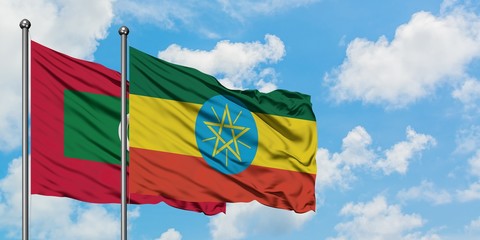 Maldives and Ethiopia flag waving in the wind against white cloudy blue sky together. Diplomacy concept, international relations.