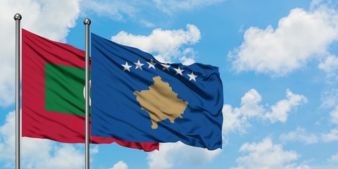 Maldives and Kosovo flag waving in the wind against white cloudy blue sky together. Diplomacy concept, international relations.
