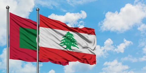Maldives and Lebanon flag waving in the wind against white cloudy blue sky together. Diplomacy concept, international relations.