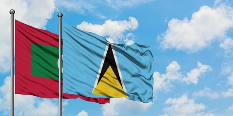 Maldives and Saint Lucia flag waving in the wind against white cloudy blue sky together. Diplomacy concept, international relations.