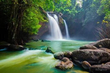 Fototapete The amazing colorful waterfall in autumn forest blue water and colorful rain forest. © APchanel