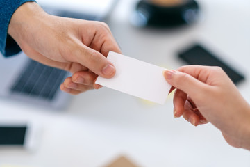 Obraz premium Two businessman holding and giving empty business card