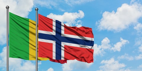 Mali and Bouvet Islands flag waving in the wind against white cloudy blue sky together. Diplomacy concept, international relations.