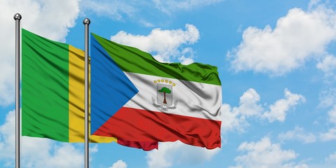 Mali and Equatorial Guinea flag waving in the wind against white cloudy blue sky together. Diplomacy concept, international relations.