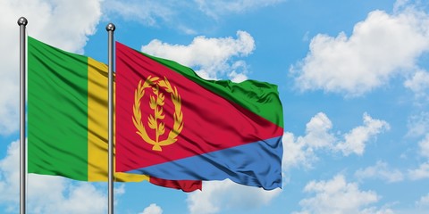 Mali and Eritrea flag waving in the wind against white cloudy blue sky together. Diplomacy concept, international relations.