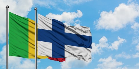 Mali and Finland flag waving in the wind against white cloudy blue sky together. Diplomacy concept, international relations.