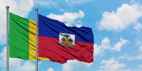 Mali and Haiti flag waving in the wind against white cloudy blue sky together. Diplomacy concept, international relations.