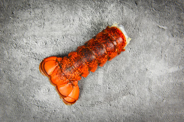 Lobster tail on dark plate background - red lobster food on dining table