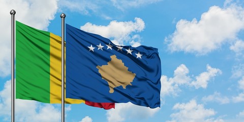 Mali and Kosovo flag waving in the wind against white cloudy blue sky together. Diplomacy concept, international relations.
