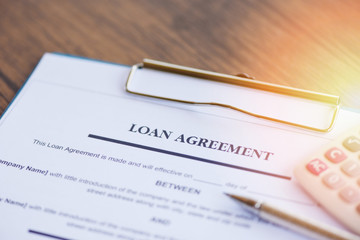 loan agreement application form with pen and calculator on paper financial help - financial loan...