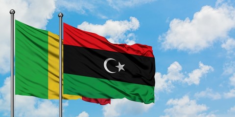 Mali and Libya flag waving in the wind against white cloudy blue sky together. Diplomacy concept,...
