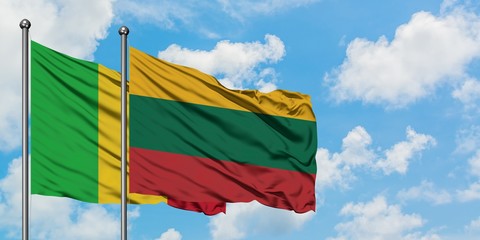 Mali and Lithuania flag waving in the wind against white cloudy blue sky together. Diplomacy concept, international relations.