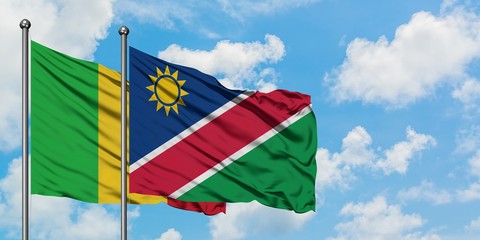 Mali and Namibia flag waving in the wind against white cloudy blue sky together. Diplomacy concept, international relations.