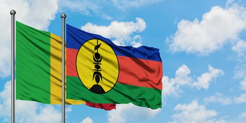 Mali and New Caledonia flag waving in the wind against white cloudy blue sky together. Diplomacy concept, international relations.