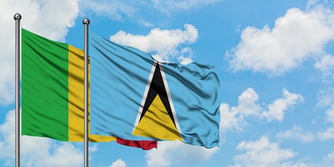 Mali and Saint Lucia flag waving in the wind against white cloudy blue sky together. Diplomacy concept, international relations.