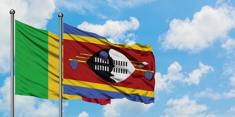 Mali and Swaziland flag waving in the wind against white cloudy blue sky together. Diplomacy concept, international relations.