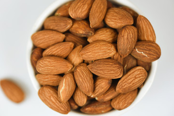 Almonds bowl isolated on gray background / Close up almond nuts natural protein food and for snack
