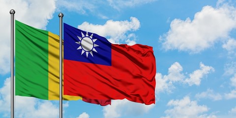 Mali and Taiwan flag waving in the wind against white cloudy blue sky together. Diplomacy concept, international relations.