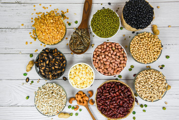 Different whole grains beans on bowl and legumes seeds lentils and nuts colorful snack background top view - Collage various beans mix peas agriculture of natural healthy food for cooking ingredients