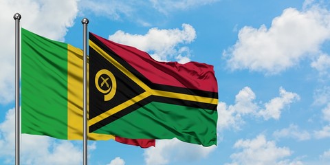 Mali and Vanuatu flag waving in the wind against white cloudy blue sky together. Diplomacy concept, international relations.