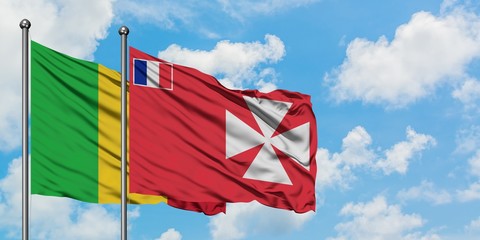 Mali and Wallis And Futuna flag waving in the wind against white cloudy blue sky together. Diplomacy concept, international relations.