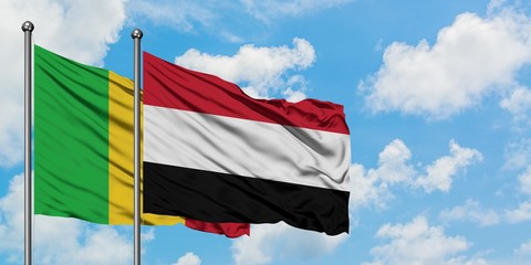 Mali and Yemen flag waving in the wind against white cloudy blue sky together. Diplomacy concept, international relations.