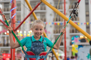 The girl is eagerly preparing to jump on the attraction.