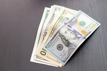 Stack of paper money. USA dollars on black table