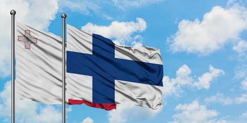 Malta and Finland flag waving in the wind against white cloudy blue sky together. Diplomacy concept, international relations.
