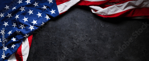 US American flag on worn black background. For USA Memorial day, Veteran's day, Labor day, or 4th of July celebration. With blank space for text.