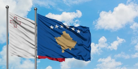 Malta and Kosovo flag waving in the wind against white cloudy blue sky together. Diplomacy concept, international relations.