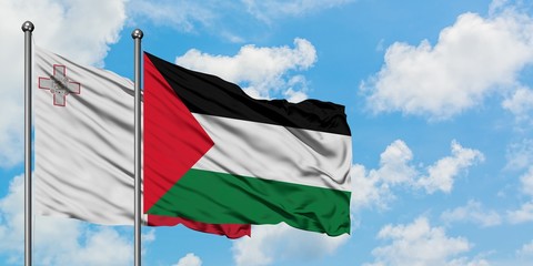 Malta and Palestine flag waving in the wind against white cloudy blue sky together. Diplomacy concept, international relations.