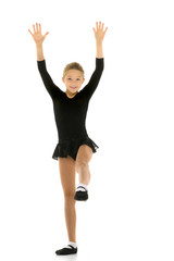 Cute little girl gymnast getting ready to perform a difficult ex