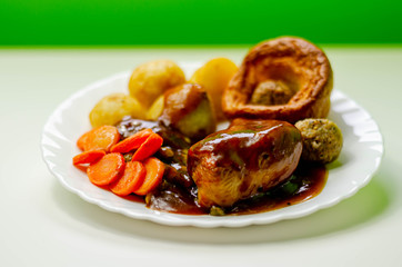 Roast potatoes and roast chicken breast in a chicken and white wine gravy with peas, carrots, pork and onion stuffing and a Yorkshire pudding